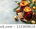 Hot red mulled wine with christmas spices, orange slice, anise and cinnamon sticks. Two glasses of mulled wine on white table with red checkered napkin with spices and fruits. Traditional Autumn drink 131909618