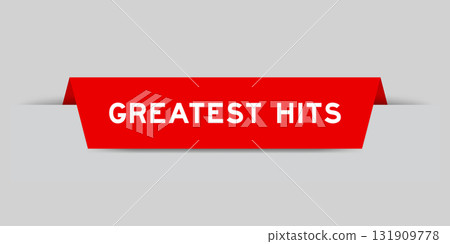 Red color inserted label with word greatest hits on gray background 131909778