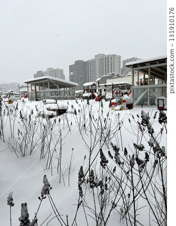 The kindergarten playground is covered in snow. An uncleared playground in winter. The kindergarten playground is covered in snow. An uncleared playground in winter. 131910176