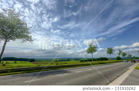 A Beautiful Scenic Roadside Landscape Featuring Lush Trees Set Against a Dramatic Sky A Beautiful Scenic Roadside Landscape Featuring Lush Trees Set Against a Dramatic Sky 131910262
