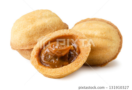 Walnut shaped cookies with condensed milk on a white. Isolated Walnut shaped cookies with condensed milk on a white. Isolated 131910327