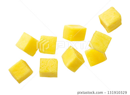 Mango cubes flying close-up on a white. Isolated 131910329