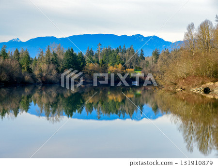 Autumn landscape scene with river, mountains and boat in a quiet factory Autumn landscape scene with river, mountains and boat in a quiet factory 131910879