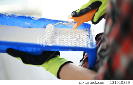 Woman With Roller Brush And Tray Getting Ready To Paint Walls White Woman With Roller Brush And Tray Getting Ready To Paint Walls White 131910889
