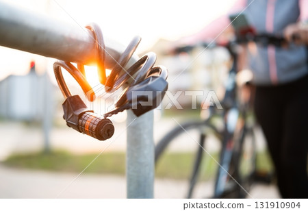 Bike Code Lock Against Bike Rider On A Bicycle Parking Rack 131910904