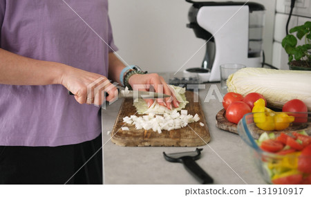 Girl Slicing Chinese Cabbage On Cutting Board For Vegetable Salad In Kitchen Girl Slicing Chinese Cabbage On Cutting Board For Vegetable Salad In Kitchen 131910917