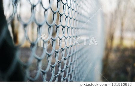 Chain-Link Fence Covered In Morning Frost Symbolizes The Concept Of Land Parcel Protection 131910953