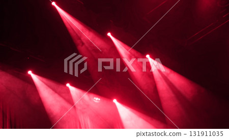Red Stage Light Shines Through Smoke During A Musical Performance 131911035