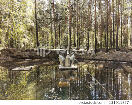 Rock crystal sculpture reflected in quiet pond surrounded by forest landscape near Lake Shartash Rock crystal sculpture reflected in quiet pond surrounded by forest landscape near Lake Shartash 131911857
