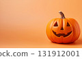Orange background with large Halloween pumpkin and copy space 131912001