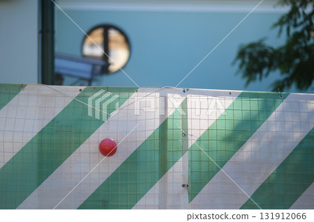 Urban Construction Barrier with Diagonal Stripes in Sunlight 131912066