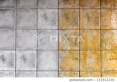 Tiles on the kitchen wall. Tiled wall half clean and half dirty, with a striking contrast. 131912216