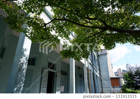 Sunlight filtering through the trees and the Western-style buildings of Dejima - Former Dejima Theological Seminary 131913315