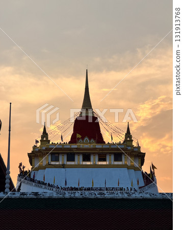 The Golden Mount Temple shines under a warm sunset sky in Bangkok reflecting peace faith and beauty of Thai culture. The Golden Mount Temple shines under a warm sunset sky in Bangkok reflecting peace faith and beauty of Thai culture. 131913768