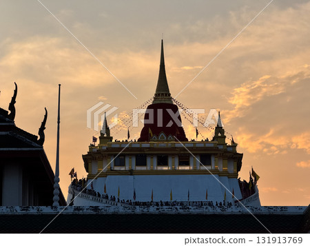 The Golden Mount Temple shines under a warm sunset sky in Bangkok reflecting peace faith and beauty of Thai culture. The Golden Mount Temple shines under a warm sunset sky in Bangkok reflecting peace faith and beauty of Thai culture. 131913769