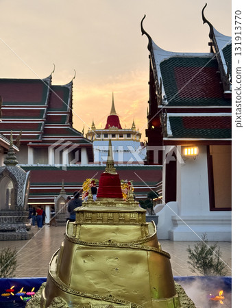 The Golden Mount Temple shines under a warm sunset sky in Bangkok reflecting peace faith and beauty of Thai culture. 131913770