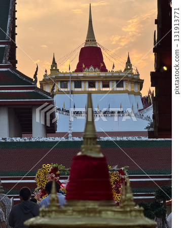 The Golden Mount Temple shines under a warm sunset sky in Bangkok reflecting peace faith and beauty of Thai culture. 131913771