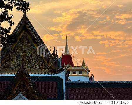 The Golden Mount Temple shines under a warm sunset sky in Bangkok reflecting peace faith and beauty of Thai culture. 131913772