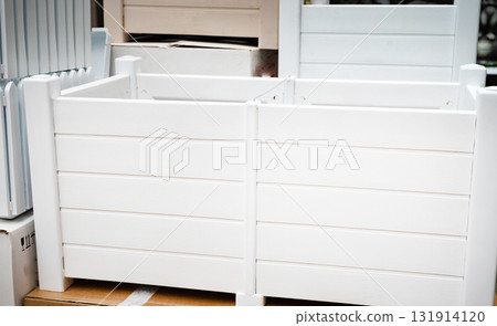 White wooden planter boxes stacked in a store. 131914120