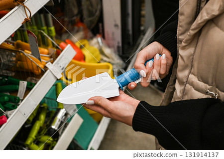 Gardening tools on display in a hardware store during a shopping trip 131914137