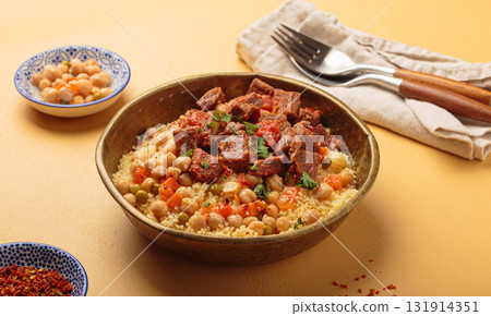 Moroccan couscous with tender meat and chickpea stew in rustic bow angle view, Maghreb cuisine 131914351