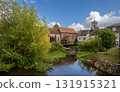 Salisbury, Wiltshire, UK: The River Avon in central Salisbury seen from Fisherton Street with St Thomas's Church in the background. 131915321