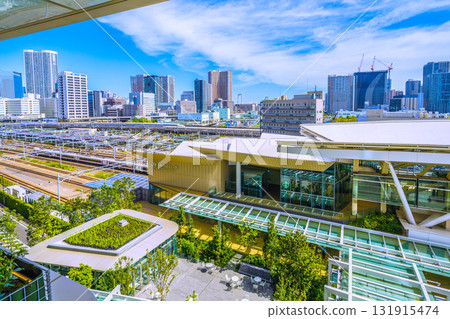 A new view of the Tokyo cityscape in Japan. Views include Takanawa Gateway Station, the Shinkansen, limited express trains, and tower apartment buildings in Shibaura. 131915474