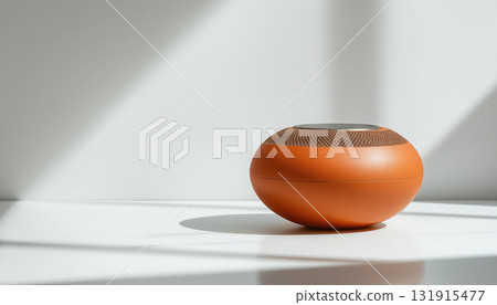 Bluetooth speaker in matte terracotta, its minimalist form pulsing with an internal glow. 131915477