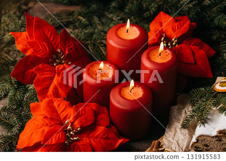 four burning Red advent candles in advent wreath decoration on wooden dark background. tradition in time before Christmas. xmas lights with christmas fir deco background concept. Festive still life. 131915583