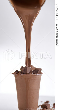Chocolate milkshake pouring into a cup with chunks 131915703