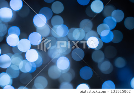 Blue bokeh light leak overlay effect, dreamy glowing circles on dark background, festive abstract light texture Blue bokeh light leak overlay effect, dreamy glowing circles on dark background, festive abstract light texture 131915902