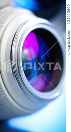Camera lens reflecting colorful light and capturing innovation 131915960