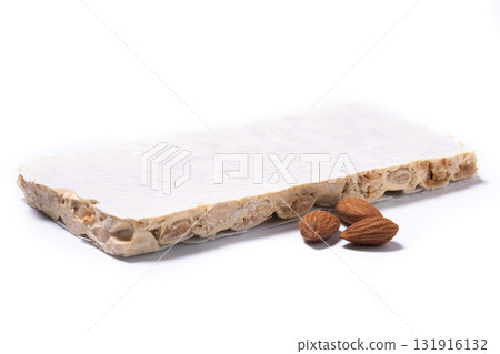 Delicious almond nougat on wooden table. Traditional Christmas sweet 131916132