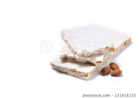 Delicious almond nougat on wooden table. Traditional Christmas sweet 131916133