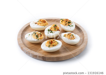 Homemade hard Boiled Deviled Eggs garnished with herbs 131916146