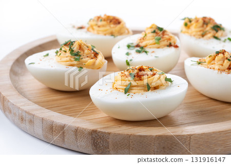 Homemade hard Boiled Deviled Eggs garnished with herbs 131916147