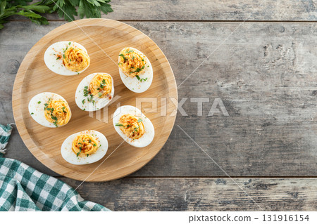 Homemade hard Boiled Deviled Eggs garnished with herbs Homemade hard Boiled Deviled Eggs garnished with herbs 131916154