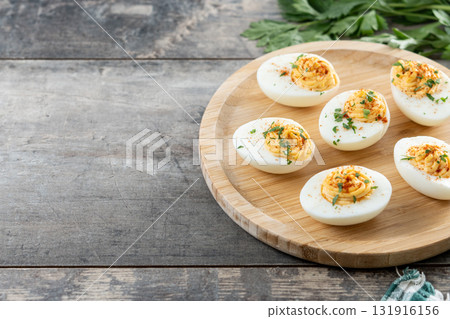 Homemade hard Boiled Deviled Eggs garnished with herbs 131916156