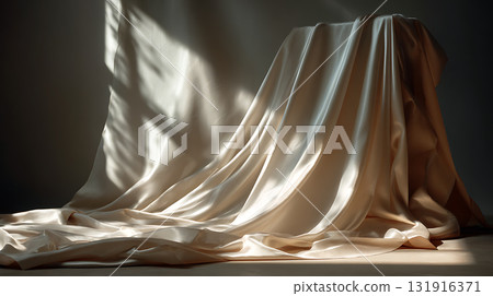 The smooth drape of the fabric and the contrast of natural light and shadow 131916371