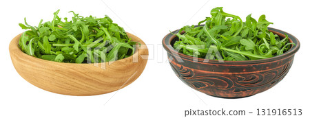 Heap of green fresh rucola or arugula leaf in wooden bowl isolated on white background 131916513