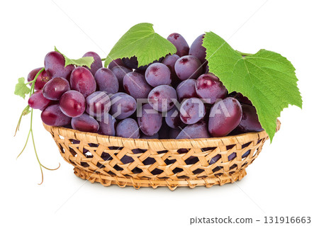 Red grape berry bunch in a wicker basket isolated on white background 131916663