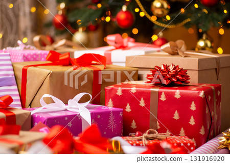 Christmas presents in colorful wrapping paper on the floor under Christmas tree. Surprises, memories, happy winter time concept Christmas presents in colorful wrapping paper on the floor under Christmas tree. Surprises, memories, happy winter time concept 131916920