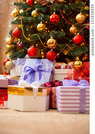 Colourful christmas presents under christmas tree on flour. Gifts for New year holidays concept Colourful christmas presents under christmas tree on flour. Gifts for New year holidays concept 131916939