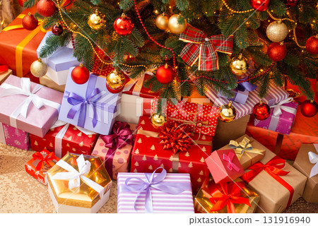 Top down shot of many boxes with Christmas presents under fir tree on flour in living room. Celebrating Christmas concept 131916940