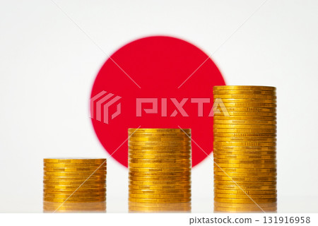 Three stacks of golden coins on the background of flag of Japan. Rise of economy of the country 131916958