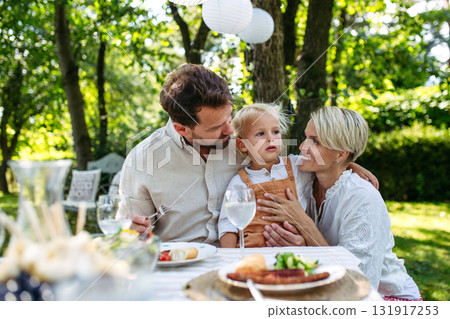Potrait of young family during grill garden party. Potrait of young family during grill garden party. 131917253