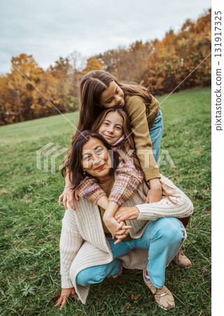 Grandmother spending time with granddaugters, walking in the nature. Multigenerational family concept. Grandmother spending time with granddaugters, walking in the nature. Multigenerational family concept. 131917325