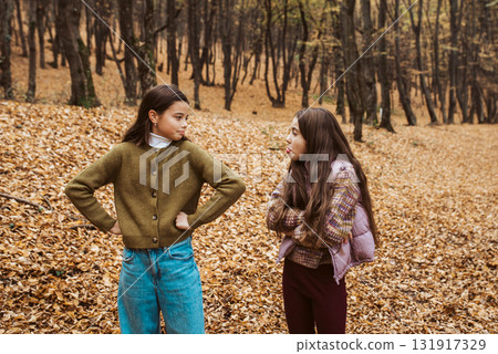 Two girls having disagreement in autumn forest. Two girls having disagreement in autumn forest. 131917329