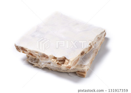 Delicious almond nougat on wooden table. Traditional Christmas sweet 131917359