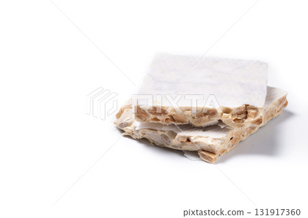 Delicious almond nougat on wooden table. Traditional Christmas sweet Delicious almond nougat on wooden table. Traditional Christmas sweet 131917360